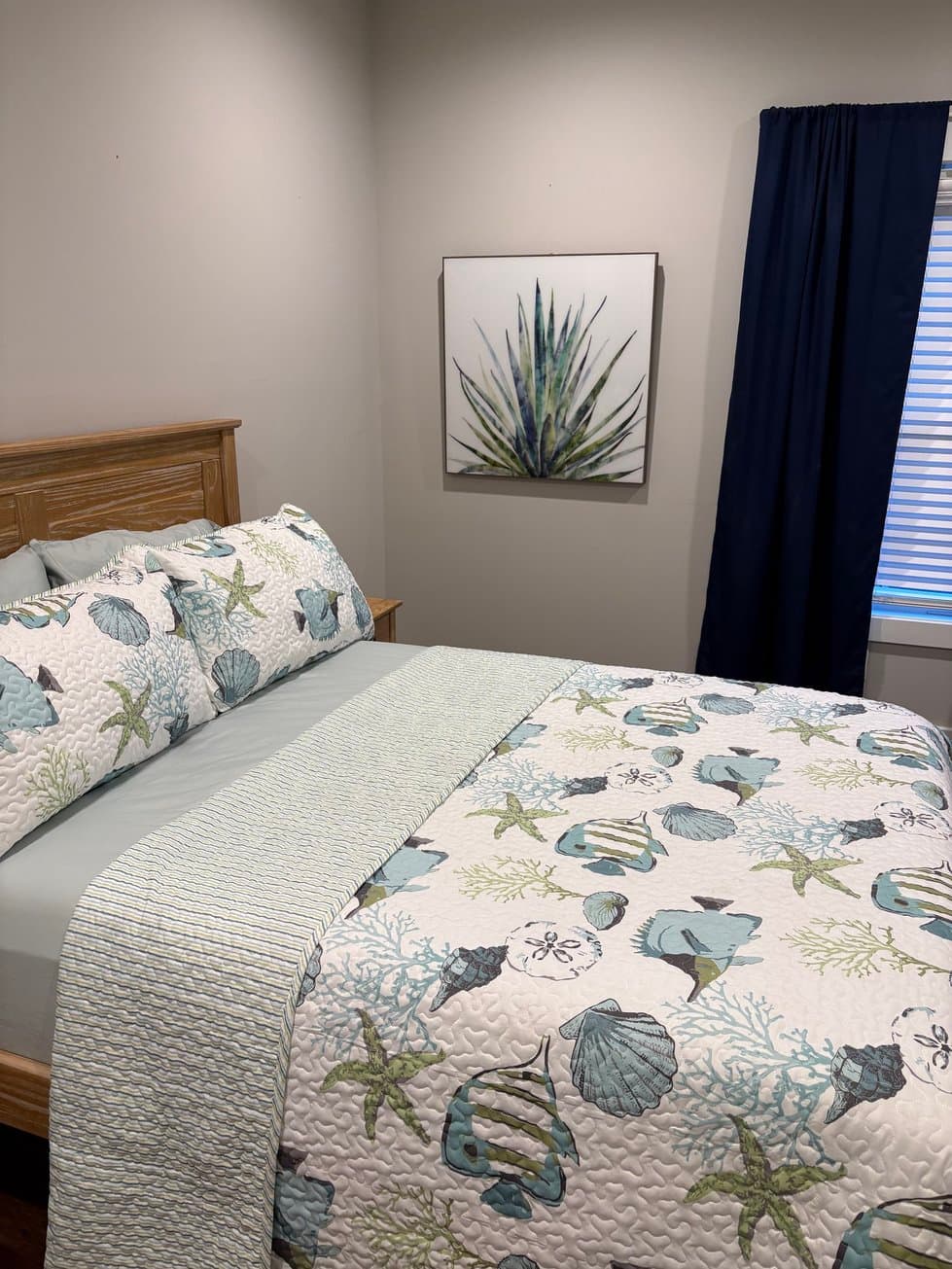 Bedroom with queen bed and coastal decor